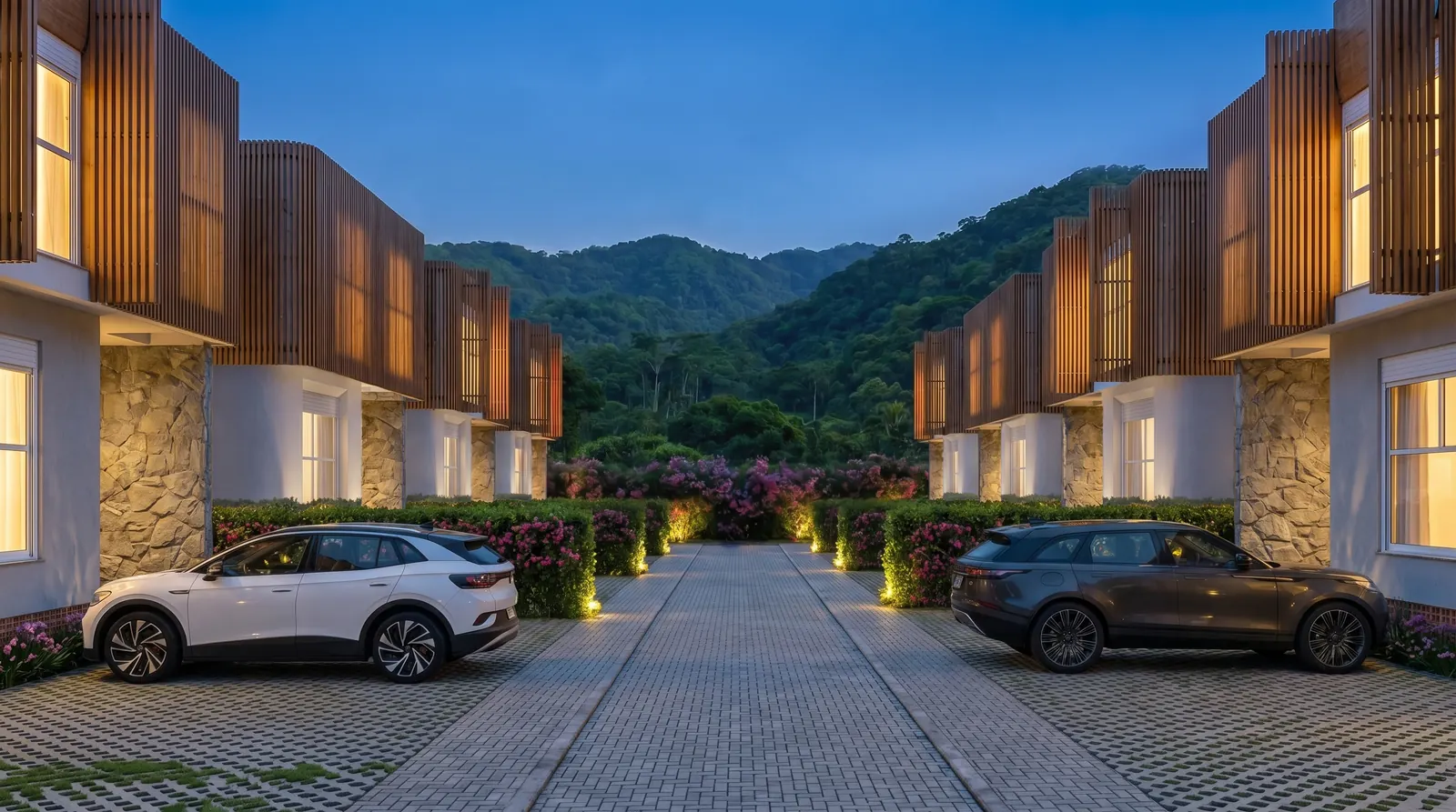 Rua interna do PRANA ao entardecer, com as casas e a serra ao fundo
